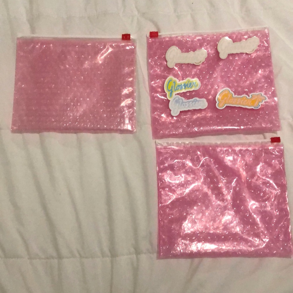 glossier pouches and stickers